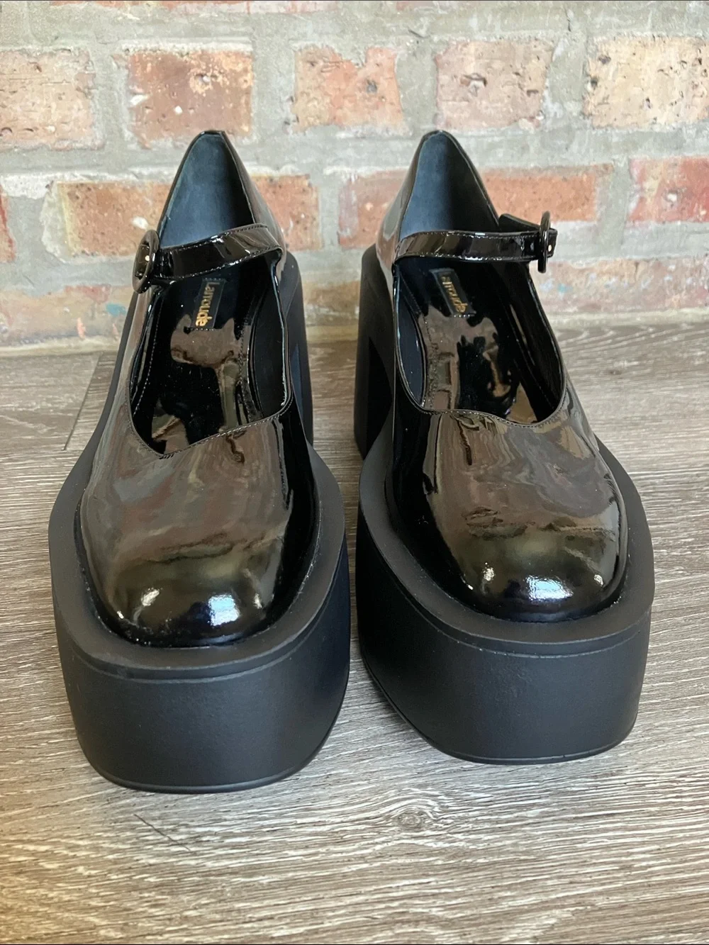 Larroude Olivia Platform Pumps in glossy black patent leather.